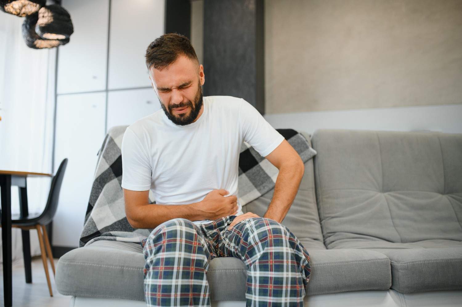 stomach-ache-man-with-abdominal-pain-suffering-home-health-problems-concept (1)